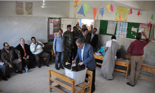 In this photo provided by Amr Moussa's Campaign, Egyptian presidential candidate Amr Moussa, casts his vote inside a polling station, in Cairo, Egypt, Wednesday, May 23, 2012. On Wednesday morning, Egypt commenced two days of presidential voting after 16 months of interim rule by the Supreme Council of Armed Forces. This election is the first free and fair race since the ouster of former President Hosni Mubarak. (AP Photo/Ahmed Almekdamy, Amr Moussa Campaign)