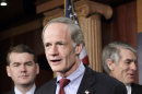 FILE - In this Feb. 8, 2011, file photo Sen. Tom Carper, D-Del., center, speaks during a Capitol Hill news conference in Washington. Carper, chairman of a subcommittee that oversees federal financial management, commented on the $77 million computer system to stop Medicare fraud before it can happen, saying he hopes for much better results. He said Medicare has 