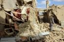 An Afghan man inspects a house destroyed during an air strike called in to protect Afghan and U.S. forces during a raid on suspected Taliban militants, in Kunduz