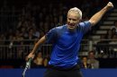 John McEnroe of the U.S. reacts after winning a point during his BNP Paribas Showdown friendly tennis match against compatriot Ivan Lendl in Hong Kong