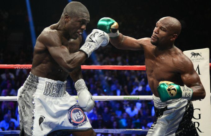 Floyd Mayweather delivers a punch to Andre Berto during their title fight on Saturday. (Getty)