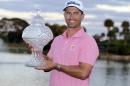 Adam Scott, of Australia, holds the trophy after winning the Honda Classic golf tournament with a 9-under-par, Sunday, Feb. 28, 2016, in Palm Beach Gardens, Fla. (AP Photo/Lynne Sladky)