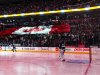 Maple Leafs goalie Reimer stands while the Canadian national anthem is played as fans hold a giant Canadian flag before his team plays the Flyers in their NHL hockey game in Toronto
