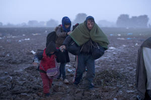 A family treks through a muddy field towards the Serbia&#39;s&nbsp;&hellip;