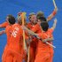 Teammates gather around Roderick Weusthof (top) of Netherlands' after a goal