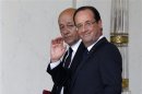 France's President Hollande and newly named Defence Minister Drian walks at the end of first cabinet meeting of the new government at the Elysee Palace in Paris