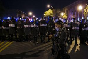 Baltimore Police officers clear the intersection of&nbsp;&hellip;