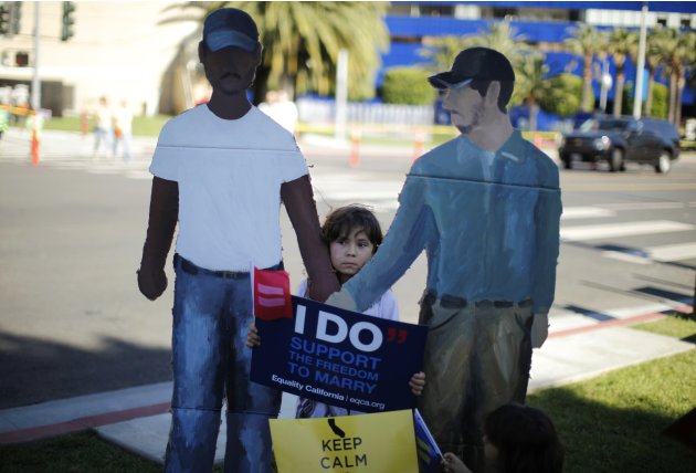 A child holds a sign at a rally in West Hollywood, after the United States Supreme Court ruled on California's Proposition 8 and the federal DOMA