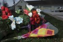 Flowers rest on the front yard at the home of Paul and Mara Skinner on Sunday, Nov. 14, 2010 in Yale, Mich., where police say two intruders stabbed the couple on Thursday. The 17-year-old daughter of two Michigan stabbing victims and two other teenagers were charged Sunday with multiple murder counts in the small-town attack that killed the girl's father and seriously wounded her mother. (AP Photo/Detroit News, Elizabeth Conley) DETROIT FREE PRESS OUT