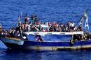 Handout picture released by the Italian Navy on August 4, 2014 shows migrants on a boat on the Mediterranean Sea after being rescued on August 3
