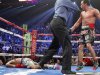 Juan Manuel Marquez of Mexico is directed to a neutral corner after knocking out Manny Pacquiao of the Philippines, during the sixth round of their welterweight fight at the MGM Grand Garden Arena in Las Vegas