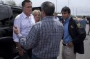 Republican presidential candidate, former Massachusetts Gov. Mitt Romney, his wife Ann, center, and Gov. Bobby Jindal, R-La., right, talk with Sen. David Vitter, R-La., back to camera, during a tour of flooding caused by hurricane Isaac, Friday, Aug. 31, 2012, in Jean Lafitte, La. (AP Photo/Evan Vucci)