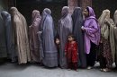 Pakistani women line up to enter a polling station and cast their ballots, on the outskirts of Islamabad, Pakistan, Saturday, May 11, 2013. Pakistanis streamed to the polls Saturday to vote in a historic election pitting a cricket star-turned-politician against an unpopular incumbent and a two-time prime minister, but twin bombings killing nine people and wounding dozens underlined the dangers voters face. (AP Photo/Muhammed Muheisen)