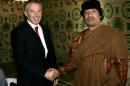 Tony Blair (left) shakes hands with Moamer Kadhafi during their 2007 meetng in the Libyan town of Sirte