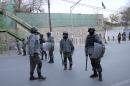 In this picture taken on Friday, Dec. 12, 2014, Afghanistan's police officers stand guard near the French Cultural Center, which was targeted by a suicide attacker in Kabul, Afghanistan. As U.S. and international combat troops leave Afghanistan after more than 13 years fighting the Talban, Afghan policemen are dying in record numbers as they perform dangerous tasks usually reserved for the military, according to the head of the European-funded mission to train the police force. (AP Photo/Massoud Hossaini)