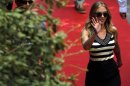 Actress Johansson waves as she arrives for a news conference for the movie "Under the Skin", directed by Glazer, during the 70th Venice Film Festival in Venice