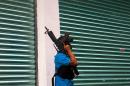 An armed member of the citizens' self-protection police stands guard in Uspero community, Michoacan State, Mexico, on January 16, 2014