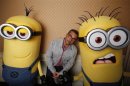 Carell poses with two life-size minion characters while promoting his upcoming movie "Despicable Me 2" in Los Angeles