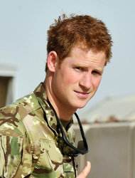 Britain's Prince Harry gives a thumbs up Friday Sept. 7, 2012 after he walked past the Apache flight-line at Camp Bastion in Afghanistan, where he will be operating from during his tour of duty as a co-pilot gunner. The Prince has returned to Afghanistan to fly attack helicopters in the fight against the Taliban. (AP Photo/ John Stillwell, Pool)