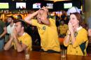 Australian fans cheer as they watch the semi-final of the 2015 Rugby World Cup at a Sydney sports bar on October 26, 2015