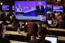 Journalists watch the Democratic presidential candidates Sen. Bernie Sanders, I-Vt., right, and Hillary Clinton speak during the CNN Democratic Presidential Primary Debate at the Brooklyn Navy Yard Thursday, April 14, 2016, New York. (AP Photo/Frank Franklin II)