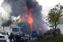 Flames rise at the scene where an explosion tore through a bus in Jerusalem