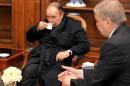 Abdelaziz Bouteflika (centre) drinks tea as he receives a visit from Algeria's Prime Minister Abdelmalek Sellal in a Paris hospital on June 11, 2013