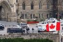 Armed RCMP officers head in to Centre Block on Parliament Hilll following a shooting incident in Ottawa