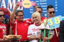 Miki Sudo, second from right, holds her trophy and smiles after winning the Nathan's Famous Fourth of July International Hot Dog Eating Contest women's competition Saturday, July 4, 2015, at Coney Island in the Brooklyn borough of New York. Sudo ate 38 hot dogs and buns in 10 minutes. (AP Photo/Tina Fineberg)(AP Photo/Tina Fineberg)