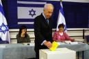 Israeli President Shimon Peres casts his vote for the municipality elections at a polling station in Jerusalem on October 22, 2013
