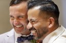 Peter Madril, left, and Monte Young embrace after getting married at City Hall in San Francisco, Saturday, June 29, 2013. Dozens of gay couples waited excitedly Saturday outside of San Francisco's City Hall as clerks resumed issuing same-sex marriage licenses, one day after a federal appeals court cleared the way for the state of California to immediately lift a 4 ½ year freeze. Big crowds were expected from across the state as long lines had already stretched down the lobby shortly after 9 a.m. City officials decided to hold weekend hours and let couples tie the knot as San Francisco is also celebrating its annual Pride weekend expected to draw as many as 1 million people. (AP Photo/Marcio Jose Sanchez)