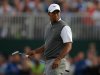 Tiger Woods of the U.S. walks across the 18th green during the third round of the British Open golf championship at Royal Lytham & St Annes