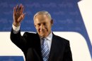 Israel's Prime Minister Benjamin Netanyahu waves to his governing Likud Party members during the Likud convention in Tel Aviv, Israel, Monday, Oct. 29, 2012. Israel's governing Likud Party has approved a merger with an ultranationalist rival, forming a hawkish bloc that appears poised to sweep upcoming parliamentary elections. The move to merge Prime Minister Benjamin Netanyahu's Likud Party with Yisrael Beitenu, which is headed by Foreign Minister Avigdor Lieberman, passed by a large majority Monday evening at a gathering of Likud activists.(AP Photo/Ariel Schalit)
