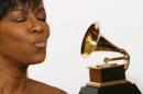 File picture shows Natalie Cole posing backstage after winning Best Traditional Pop Vocal Album for "Still Unforgettable" at the 51st annual Grammy Awards in Los Angeles