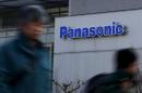 Pedestrians walk past a logo of Panasonic Corp outside Panasonic Center in Tokyo