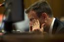 Oscar Pistorius reacts as he listens to evidence by a pathologist in court in Pretoria, South Africa, Monday, April 7, 2014. A pathologist called as the first defense witness in the Oscar Pistorius murder trial offered a different sequence for the shots that killed Reeva Steenkamp and also testified Monday that if the double-amputee athlete fired his 9 mmm pistol in two quick bursts, as Pistorius claims he did, his girlfriend probably didn't have time to scream. Pistorius is charged with murder for the shooting death of his girlfriend Reeva Steenkamp, on Valentines Day 2013. (AP Photo/Deaan Vivier, Pool)