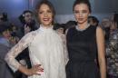 Jessica Alba, left and Miranda Kerr pose prior to the show of H&M's ready-to-wear fall/winter 2014-2015 fashion collection presented in Paris, Wednesday, Feb. 26, 2014. (AP Photo/Jacques Brinon)
