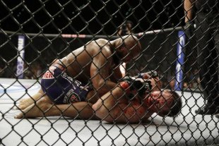 Yoel Romero pins Tim Kennedy during their fight in 2014. (AP)