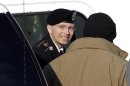 FILE - In this Nov. 28, 2012 file photo, Army Pfc. Bradley Manning, center, steps out of a security vehicle as he is escorted into a courthouse in Fort Meade, Md., for a pretrial hearing. A military judge hears closing arguments on Tuesday, Dec. 12, 2012, on whether a private charged with sending classified material to WikiLeaks suffered illegal pretrial punishment during nine months in a Marine Corps brig. Army Pfc. Bradley Manning's lawyers claim his treatment was so egregious that all charges should be dismissed. (AP Photo/Patrick Semansky, HO)