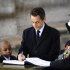 France's President Nicolas Sarkozy signs a book next to children of soldiers killed on duty, at the tomb of the Unknown soldier at the Arc de Triomphe in Paris, Friday, Nov.11, 2011. Sarkozy pays homage to French forces killed in World War I and other conflicts. (AP Photo/Lionel Bonaventure, Pool)