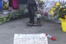 A statuette is seen near other mementos and messages left at the scene of a policeman's shooting in Houston
