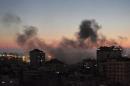 Smoke from fires caused by Israeli strikes, rises over Gaza City, Sunday, Aug. 10, 2014. (AP Photo/Lefteris Pitarakis)