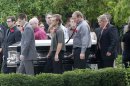 Pallbearers carry Matt McQuinn, killed in the Aurora, Colorado movie theater shooting, from the church after his funeral Saturday, July 28, 2012, in Springfield, Ohio. McQuinn shielded his girlfriend, Samantha Yowler, from gunfire during the shooting. Twelve people were killed and dozens were wounded in a shooting attack last Friday at a packed movie theater during a showing of the Batman movie, "The Dark Knight Rises." Police have identified the suspected shooter as James Holmes, 24. (AP Photo/Jay LaPrete)