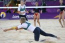 Natalie Cook from Australia dives for a ball during the Beach Volleyball match against USA at the 2012 Summer Olympics, Saturday, July 28, 2012, in London. (AP Photo/Petr David Josek)