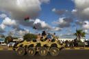 Libyan troops sit on an amoured personnel carrier during a demonstration on August 14, 2015 in the eastern Libyan city of Benghazi