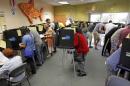 South Floridians mark their ballots during the last day of early voting in Miami Beach
