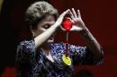 Brazil's President and presidential candidate Dilma Rousseff of the Workers Party (PT) holds a star toy during a meeting with educators in Sao Paulo