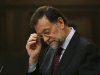 Spain's Prime Minister Rajoy adjusts his glasses as he delivers a speech on the results of the last European Council at the Spanish parliament in Madrid