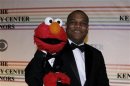 Elmo and Kevin Clash pose for photographers on the red carpet at the Kennedy Center in Washington