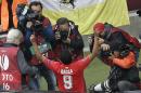 Sevilla's Carlos Bacca celebrates surrounded by photographers after scoring during the final of the soccer Europa League between FC Dnipro Dnipropetrovsk and Sevilla FC at the National Stadium in Warsaw, Poland, Wednesday, May 27, 2015. (AP Photo/Michael Sohn)